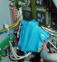The internal parallel port is wrapped in a blue heat-shrink tube. The new external port (the red one)                     is seated in the hole that was left.